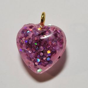 Double sided heart glitter pendant.